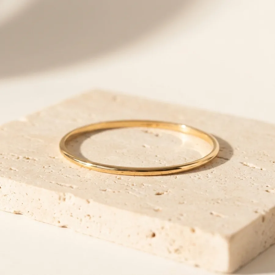 Gold bangle bracelet in the same signature warm-daylight style