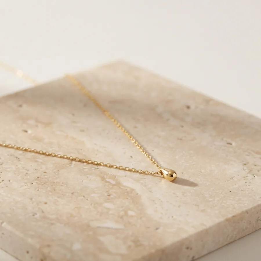 Gold pendant necklace in the same signature warm-daylight style