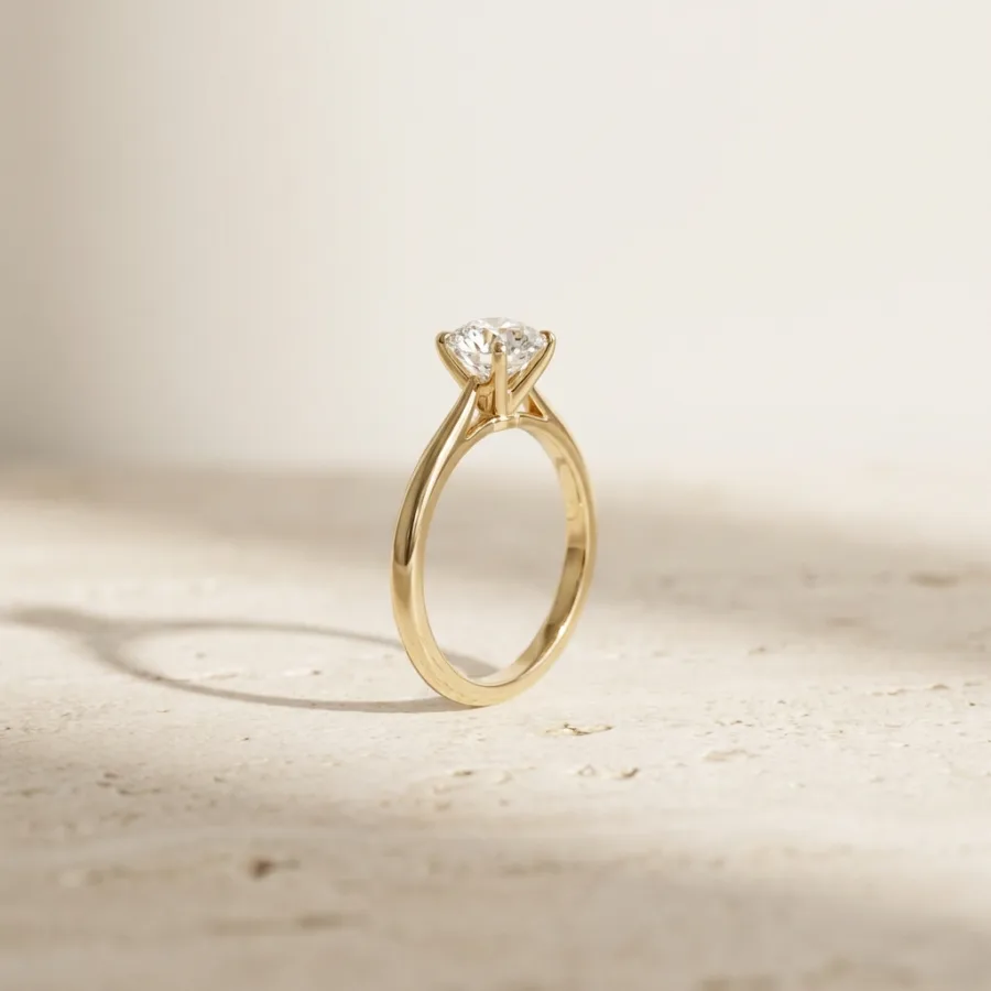 Gold solitaire ring photographed in the shop's signature warm-daylight style